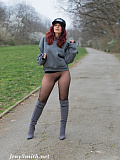 Jeny walks outdoors without a skirt, wearing only seamless dot patterned pantyhose to cover her legs.