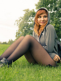 Jeny Smith dressed as a teenager flashing her goodies in grey seamless pantyhose in the park