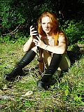 Hot redhead huntress is relaxing in the woods in her green pantyhose
